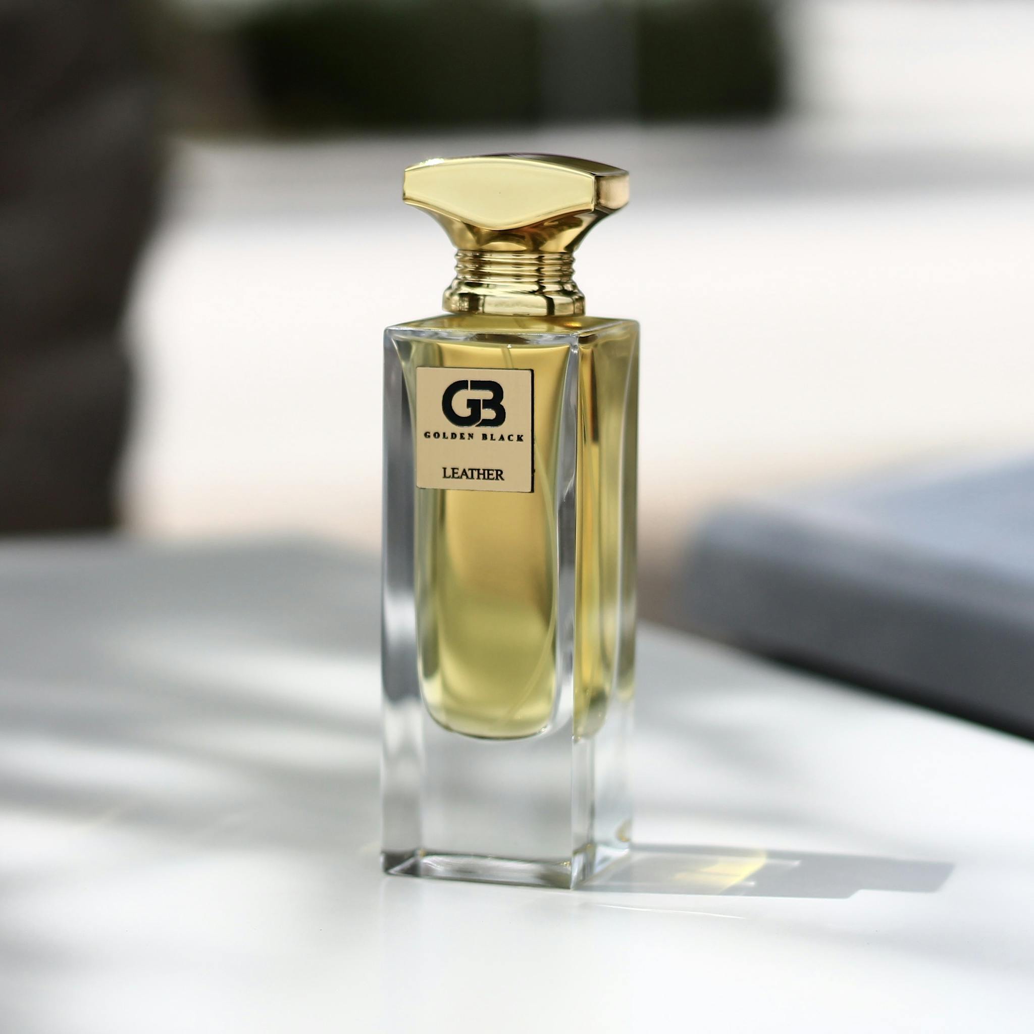 Luxurious perfume bottle in selective focus with natural light and shadows highlighting its design.